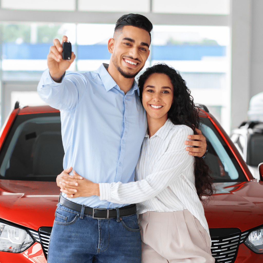 Couple Smiling front of the car