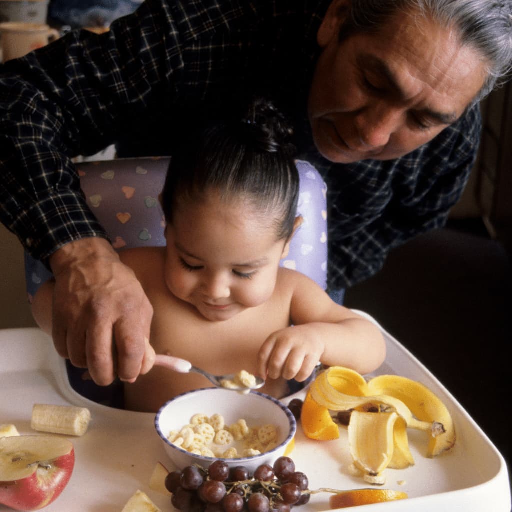Father Teaching the baby to eat